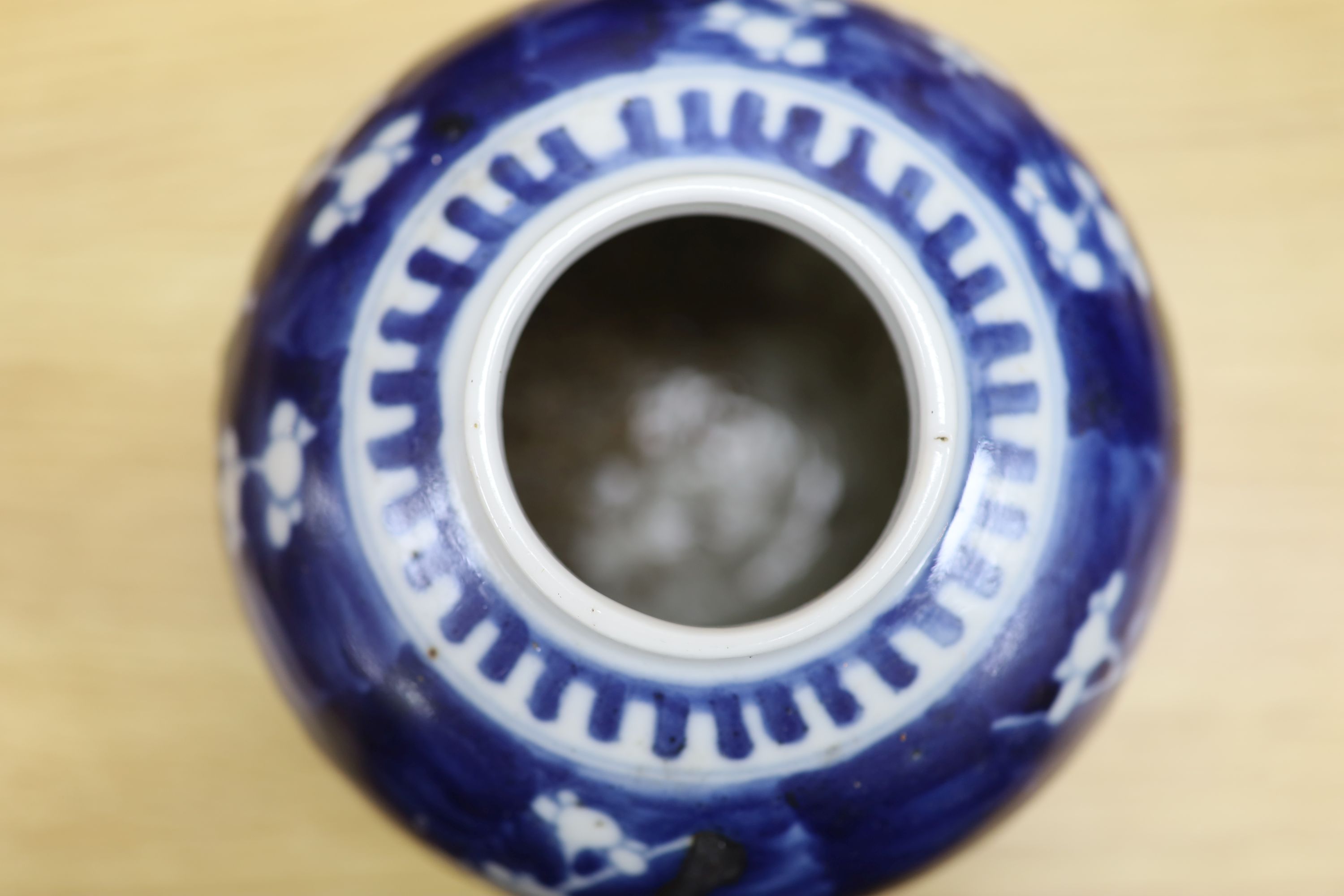 Two Chinese blue and white prunus pattern ginger jars and a similar cylinder vase, tallest 26cm